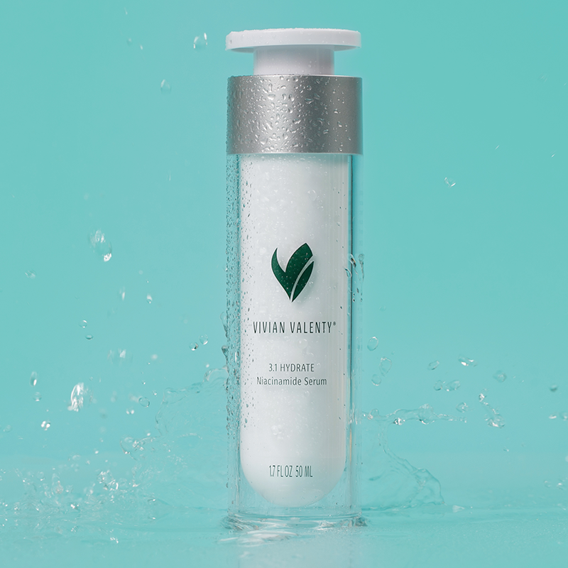 Step 3.1 Vivian Valenty Skincare Hydrate on a turquoise background with water droplets and a fresh apple, representing clean, fresh, and healthy skin.