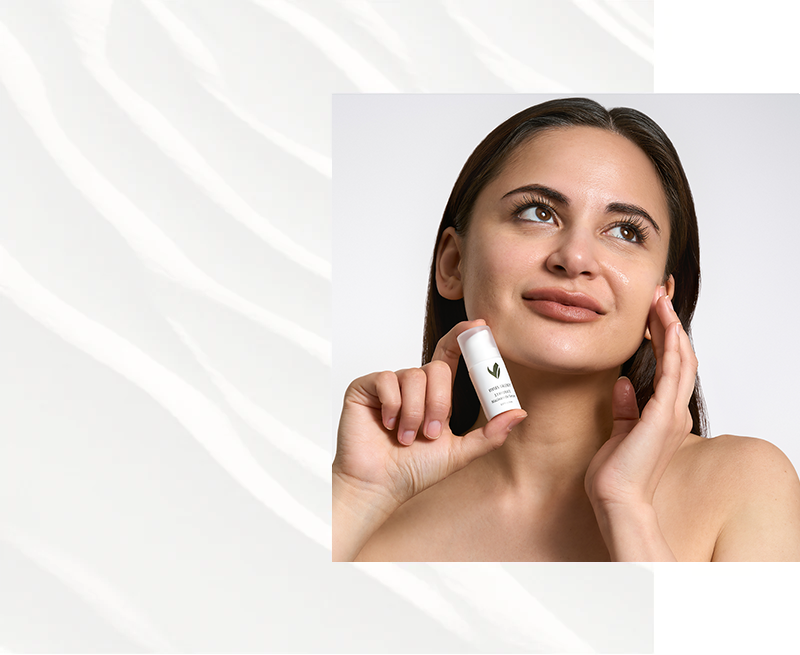 Glowing skin on a model holding a Vivian Valenty Skincare bottle, showcasing radiant, healthy skin with our clean and effective skincare formula.