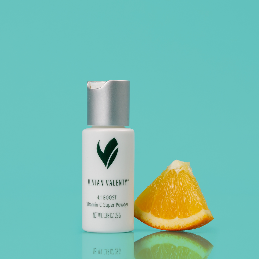 Step 4.1: Vivian Valenty Skincare Boost on a turquoise background with water droplets and a fresh Orange, representing clean, fresh, and healthy skin.